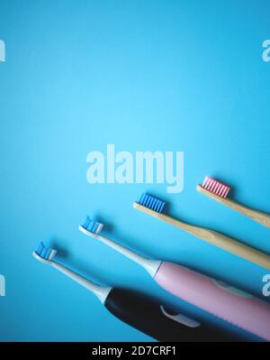 two ultrasonic electric toothbrushes on a blue background Stock Photo