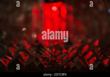Close up of crystal facets in mysterious ruby light. Stock Photo