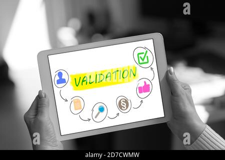 Validation concept shown on a tablet held by a woman Stock Photo
