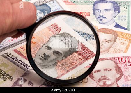 Cuban peso in a magnifying glass Stock Photo