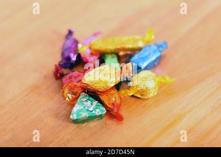 Pile of Quality Street toffee and chocolate sweets in wrappers, close up Stock Photo