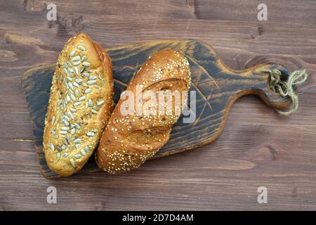 bread bun on cutting board over rustic wooden background Stock Photo