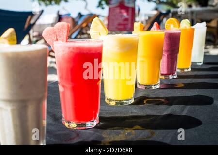 A selection of Fruit shakes displayed together in formation on a table bar Stock Photo