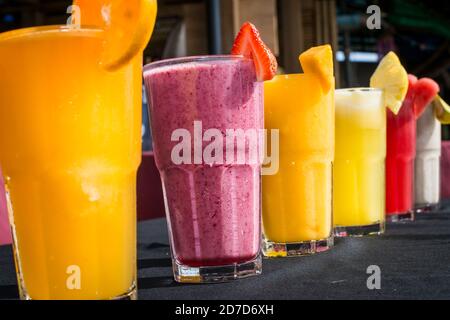 A selection of Fruit shakes displayed together in formation on a table bar Stock Photo