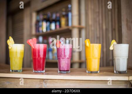 A selection of Fruit shakes displayed together in formation on a table bar Stock Photo