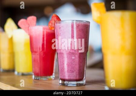 A selection of Fruit shakes displayed together in formation on a table bar Stock Photo