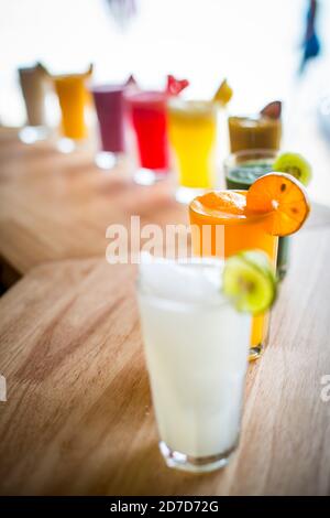 A selection of Fruit shakes displayed together in formation on a table bar Stock Photo