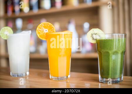 A selection of Fruit shakes displayed together in formation on a table bar Stock Photo