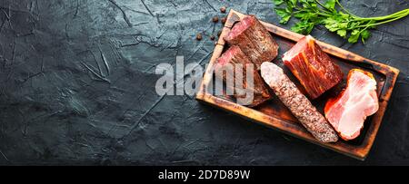 Spanish meat platter.Cured meat and sausages on cutting board.Space for text Stock Photo