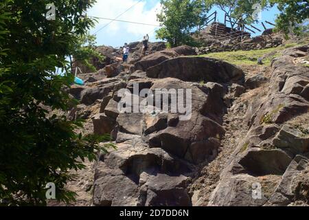 two boys climb with a steel rope in an alpine adventure park Stock Photo