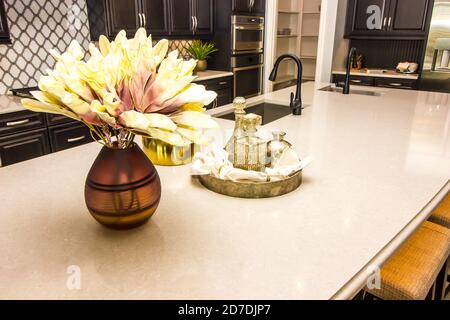 Modern Kitchen With Decorator Items On Island With Two Sinks Stock Photo