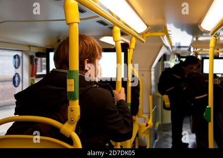 21 October 2020, Berlin: A man with his mouth and nose covered is sitting in the new BVG biplane. Bus of the type 'Alexander Dennis Enviro500' is parked at the BVG bus depot Müllerstraße. The Berlin public transport company is presenting two new BVG double-decker buses. The bus has room for 112 passengers, is 2.55 metres wide and 4.06 metres high. From mid-November, the vehicles are scheduled to run on Line 100. Photo: Kira Hofmann/dpa-Zentralbild/ZB Stock Photo