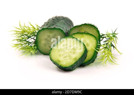 Sliced cucumber with greens beautiful composition on white isolated background Stock Photo