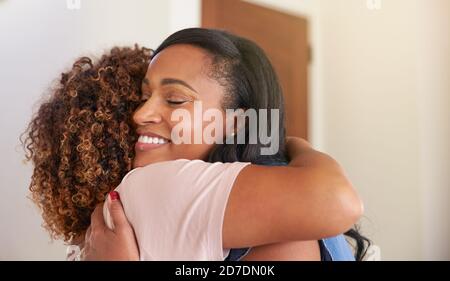 Loving Senior Mother Hugging Adult Daughter Indoors At Home Stock Photo