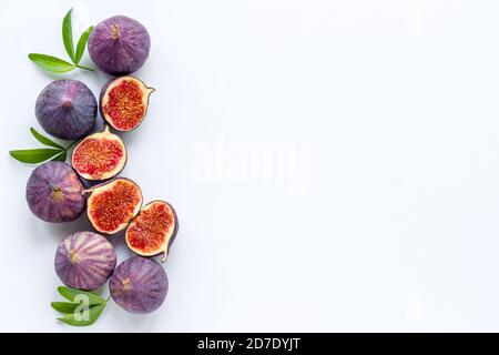 Tasty fresh figs cut in half with leaves, top view Stock Photo