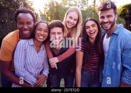 Portrait Of Group Of Multi-Cultural Friends Enjoying Outdoor Summer Garden Party Stock Photo