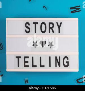 Tell stories to sell. Storytelling concept layout on blue Stock Photo