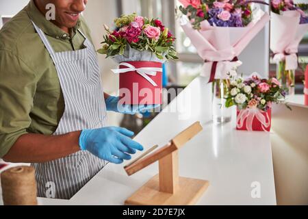 Carefree flower shop assistant using a tablet Stock Photo