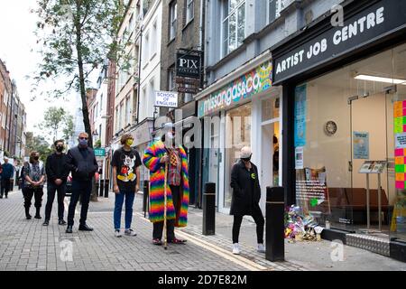 EDITORIAL USE ONLY (Left to right) Mike Spearman, Suggs, Stuart Semple, Eek the clown and Gail Porter queue for artist Stuart Semple's new art installation entitled the 'Artist Job Centre' in Neal Street, London. Stock Photo