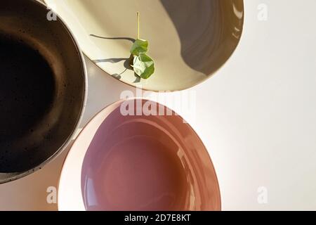 Modern design plates ofpastel colors in natural sunlight, top view Stock Photo