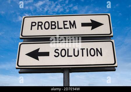 Problem and solution on white two street signs with arrow on metal pole with word. Directional road. Crossroads Road Sign, Two Arrow. Blue sky backgro Stock Photo