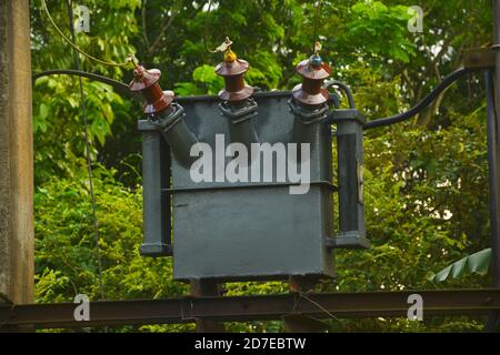 Close up of a three  phase transformer with ceramic insulators and wires on a high  mount, selective focusing Stock Photo