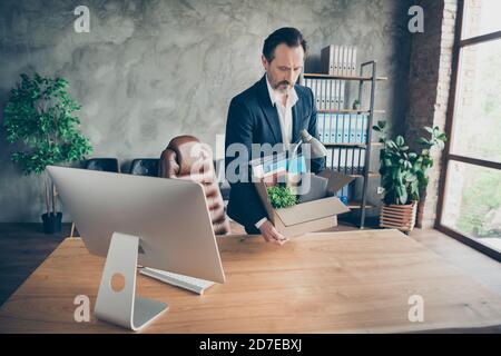 Photo of moody tired dismissed worker guy laid off fired manager loser lost job work carry belongings carton box financial crisis crash leaving modern Stock Photo