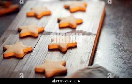 Freshly Baked Star Shaped Christmas Cookies On Board Ready For Decoration Stock Photo