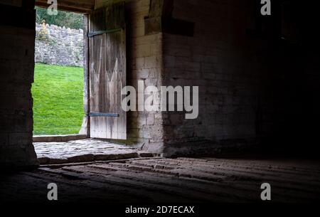 The Tithe Barn on Pound Lane, medieval stone barn in the Barton Grange complex on the River Avon in Bradford on Avon in the Cotwolds, Wiltshire, UK Stock Photo