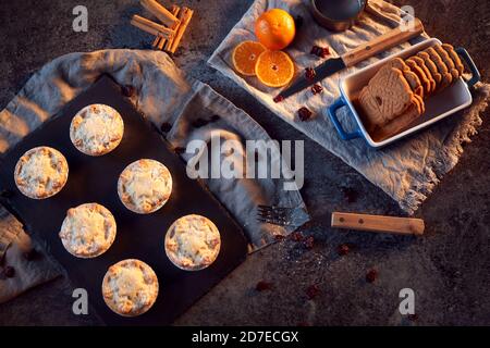 Freshly Baked Mince Pies And Cookies On Table Set For Christmas With Cinnamon Sticks And Orange Stock Photo