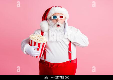 Portrait of his he nice attractive terrified worried impressed frightened bearded fat overweight Santa watching scary horror film thriller eating corn Stock Photo