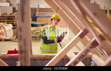 Female Safety Inspector With Digital Tablet At Construction Site Stock Photo