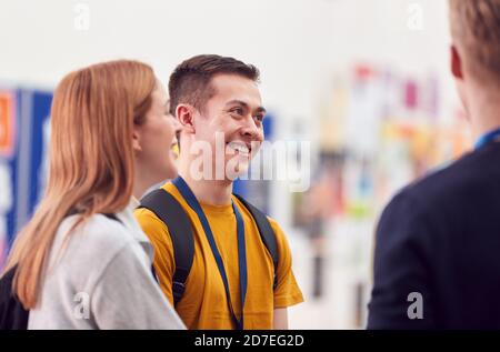 Group Of College Student Friends Meeting And Talking In Busy Communal Campus Building Stock Photo