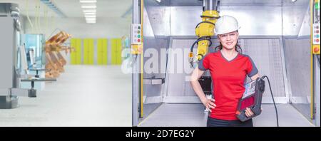 A young female technician while machine constructing in a manufacturing plant Stock Photo
