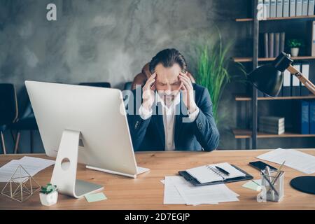 Portrait of his he nice handsome frustrated tired exhausted man executive expert specialist agent broker feeling dizzy bad syndrome at modern Stock Photo