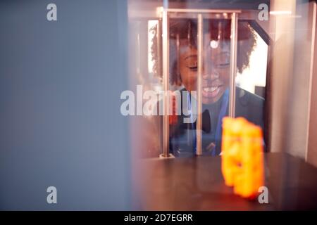 Female College Student Studying Engineering Using 3D Printing Machine Stock Photo
