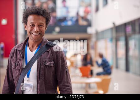 Portrait Of Mature Male Teacher Or Student In College Hall Stock Photo