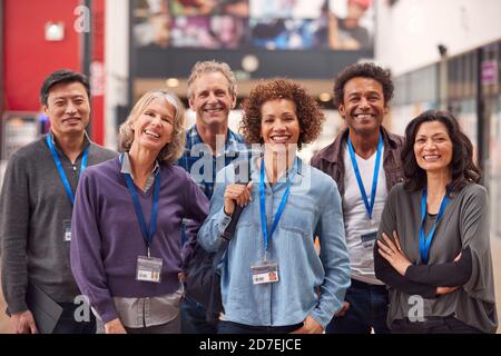 Portrait Of Group Of Smiling Mature Students Standing In College Hall Stock Photo