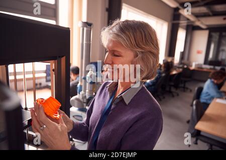 Mature Female College Student Studying Engineering Using 3D Printing Machine Stock Photo