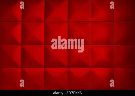 Rhombic red color wall of big squares. Background consists of large red squares. Unusual, beautiful and modern background. Stock Photo