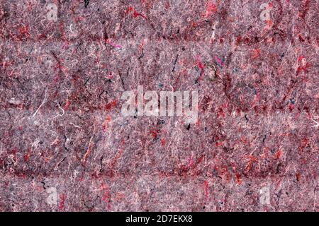 Background of red lining with fibers from non-uniform fabric. Texture of grey felt material. Stock Photo