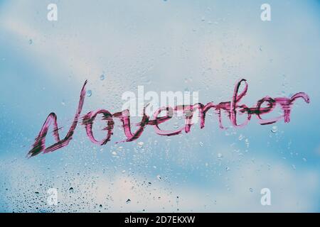 Inscription november lipstick on a window pane Stock Photo