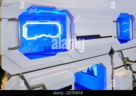 Capsule hotel open entrance hole with visible inside interior airport. Blue light inside the room mini-hotel in mobile vacation spot for travel. Stock Photo