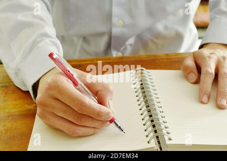 hand writing on white paper book binding Stock Photo