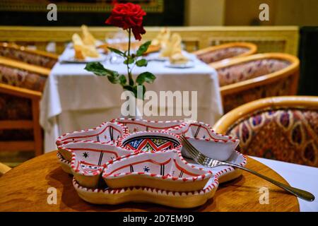 Red rose on table in arabic restaurant, close up Stock Photo
