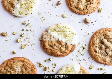 Overhead horizontal view of pistachio and white chocolate cookies on a white marble tabletop. Stock Photo
