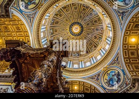 ROME, ITALY - SEPTEMBER 27, 2018: Bottom view of St. Peter's Baldachin designed by Gian Lorenzo Bernini in 1634 against the dome of the St. Peter's Ba Stock Photo