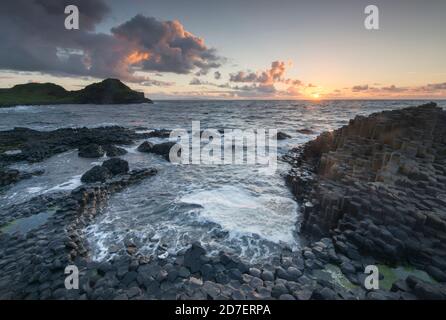 Sunset at the Giant's Causeway, a UNESCO world heritage site of some 40,000 hexagonal columns on the Antrim coast of Northern Ireland. Stock Photo