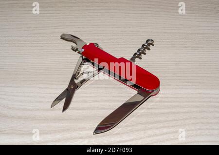 Multipurpose swiss army knife on wooden table Stock Photo