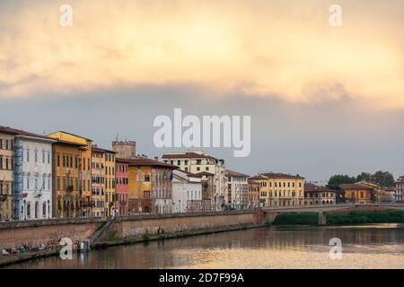 Dramatic clouds over the river Arno at sunset as seen from the Ponte Di Mezzo bridge, Pisa, Tuscany, Italy Stock Photo